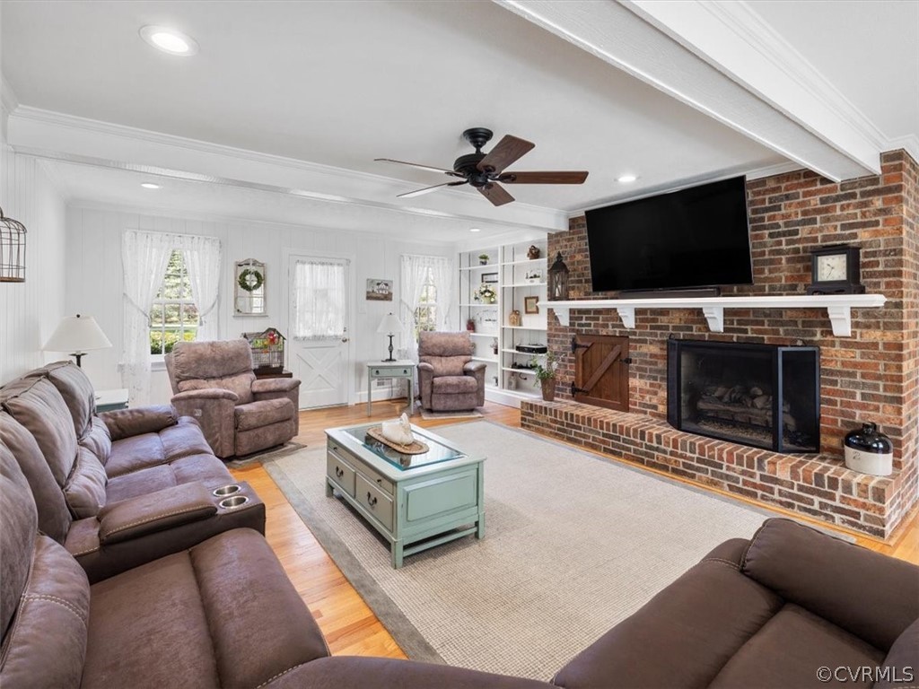 2931 West Brigstock Road Midlothian, VA 23113 - Photo 3 of 46 a living room with furniture a flat screen tv and a fireplace
