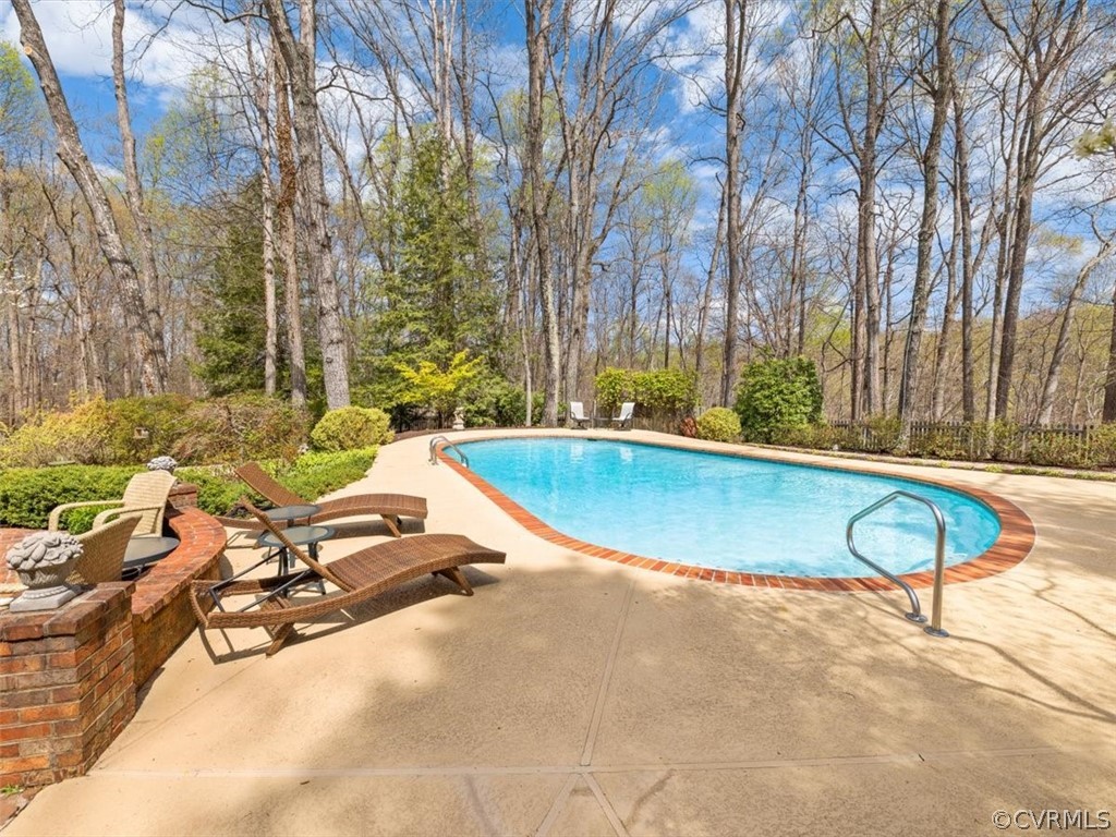 2931 West Brigstock Road Midlothian, VA 23113 - Photo 39 of 46 a view of a swimming pool with a lounge chairs