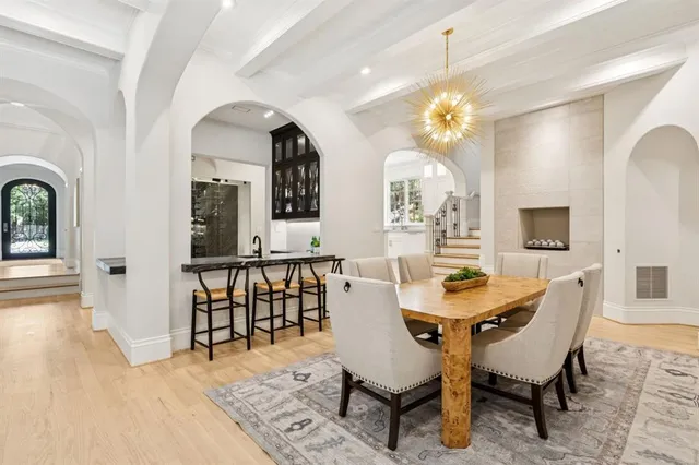 a view of a dining room with furniture and a chandelier