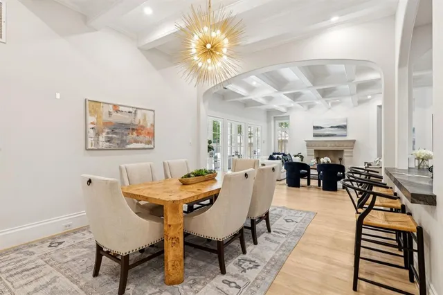 a view of a dining room with furniture a chandelier and wooden floor