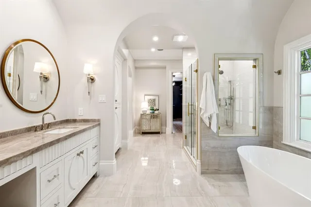 a spacious bathroom with a granite countertop sink and a mirror