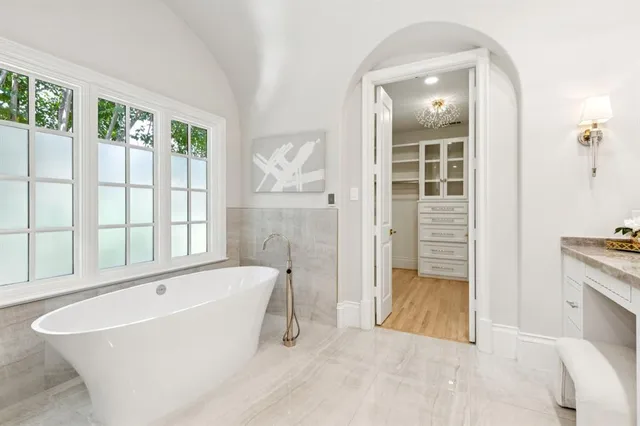 a spacious bathroom with a tub and a shower