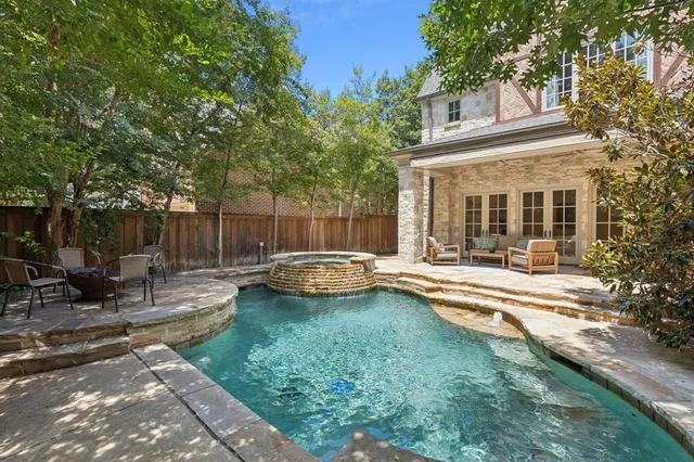 a view of a house with swimming pool and sitting area