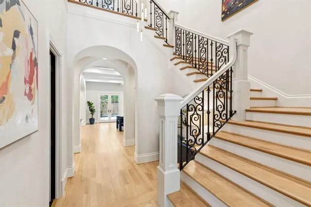 a view of staircase with wooden floor and a rug