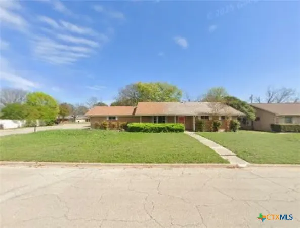 a view of a house with a yard and plants