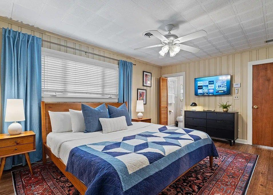 264 Euharlee Road Southwest Cartersville, GA 30120 - Photo 19 of 45 a bedroom with a large bed and a chandelier