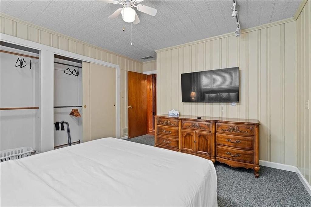 264 Euharlee Road Southwest Cartersville, GA 30120 - Photo 32 of 45 a bedroom with a bed and a flat screen tv in it