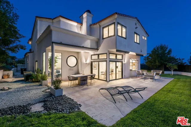 a view of a house with backyard porch and sitting area