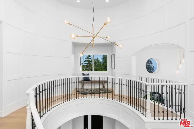 a living room with furniture a fireplace and a floor to ceiling window