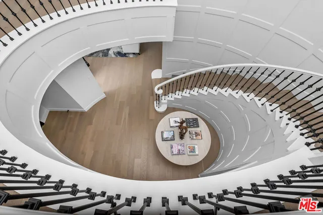 a living room with furniture a chandelier and a window