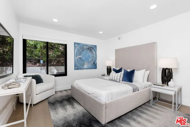 a bedroom with a bed and a lamp