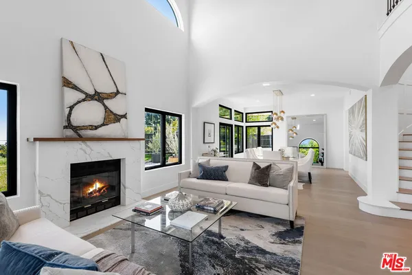 a kitchen with stainless steel appliances kitchen island granite countertop a refrigerator and a stove top oven