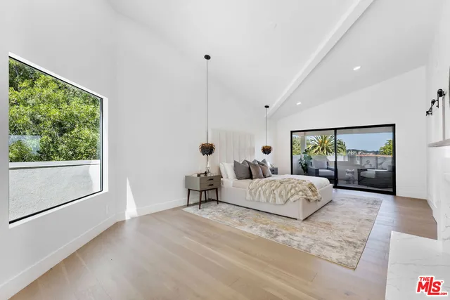 a bedroom with a bed and a painting on the wall