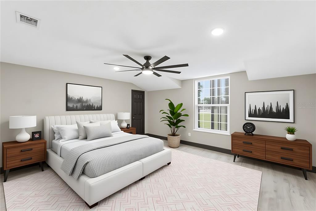 14728 Henson Road Orlando, FL 32832 - Photo 71 of 79 a bedroom with a large bed and a couch