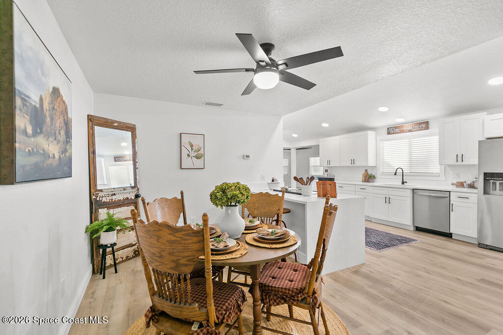 1815 Ford Road Mims, FL 32754 - Photo 17 of 59 a view of a dining room with furniture and wooden floor