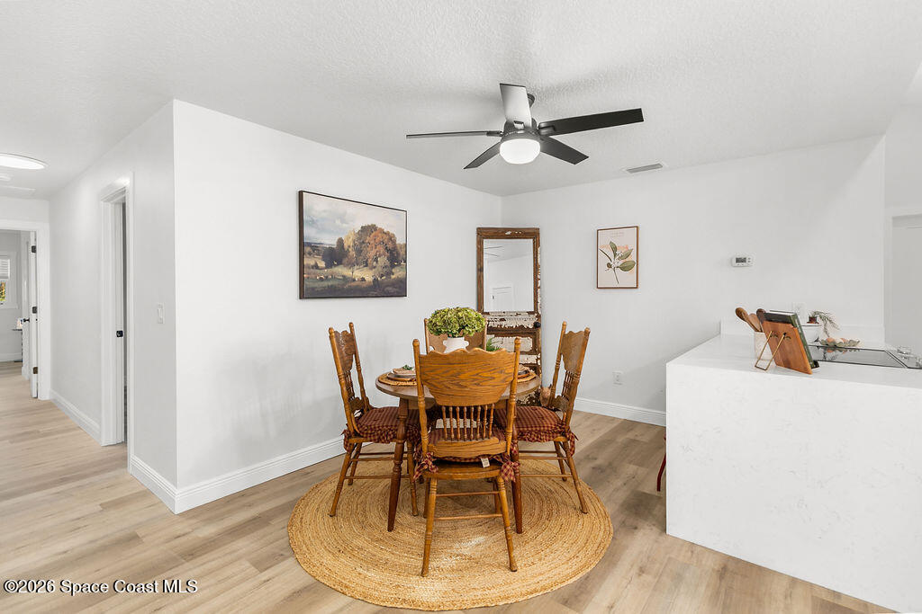 1815 Ford Road Mims, FL 32754 - Photo 18 of 59 a view of a dining room with furniture and wooden floor