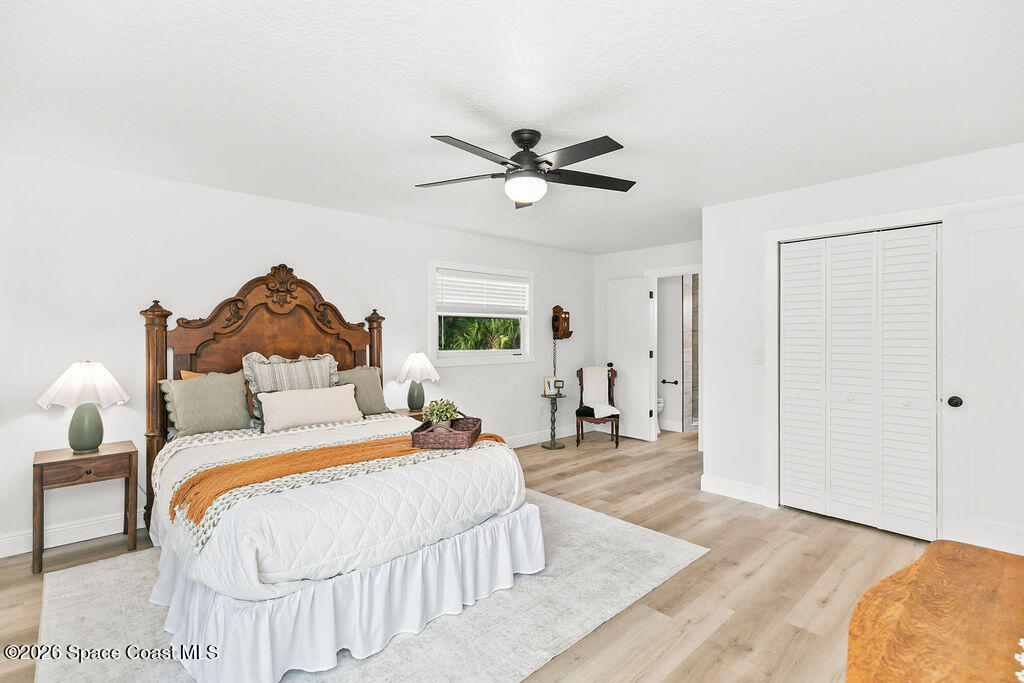 1815 Ford Road Mims, FL 32754 - Photo 21 of 59 a bedroom with a bed and wooden floor