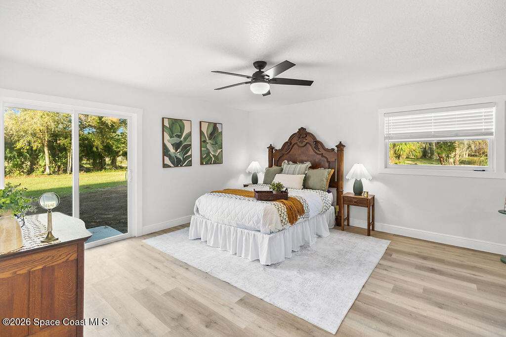 1815 Ford Road Mims, FL 32754 - Photo 22 of 59 a spacious bedroom with a bed and a large window