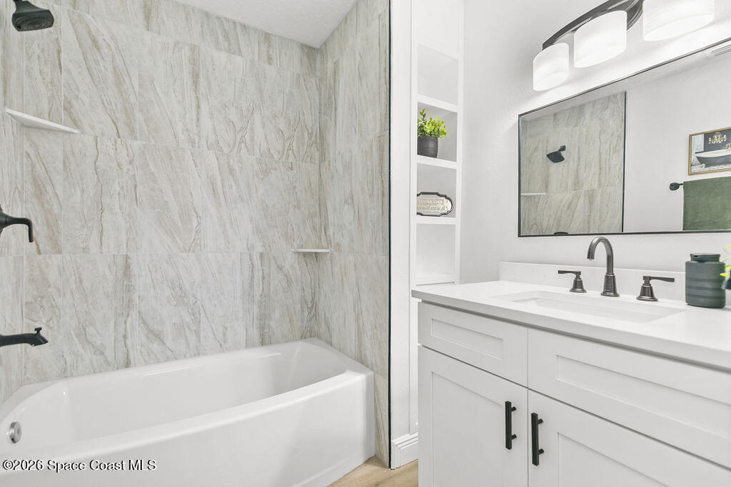 1815 Ford Road Mims, FL 32754 - Photo 25 of 59 a bathroom with a tub a sink and mirror