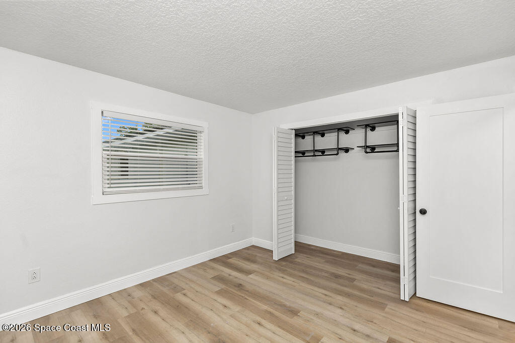 1815 Ford Road Mims, FL 32754 - Photo 30 of 59 a view of an empty room with wooden floor and a window