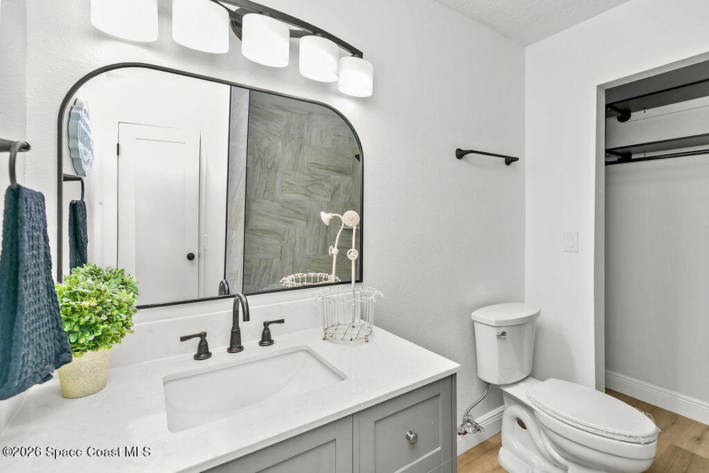 1815 Ford Road Mims, FL 32754 - Photo 31 of 59 a bathroom with a sink a toilet and a mirror