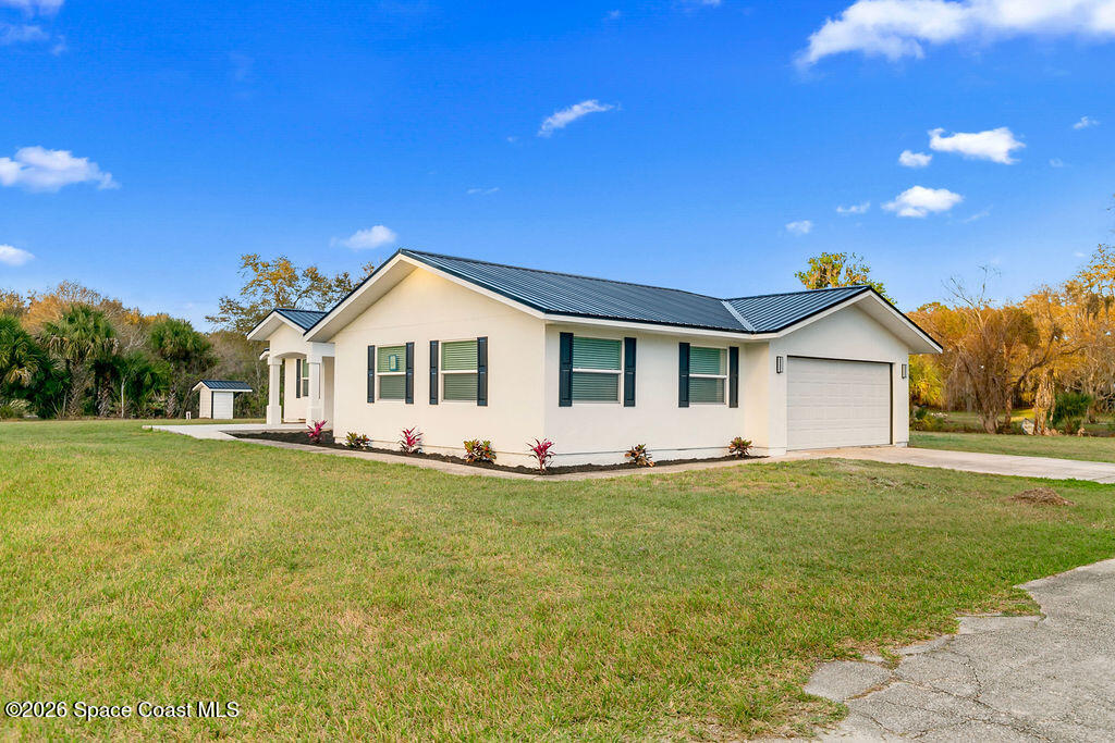 1815 Ford Road Mims, FL 32754 - Photo 40 of 59 a front view of a house with a garden and yard
