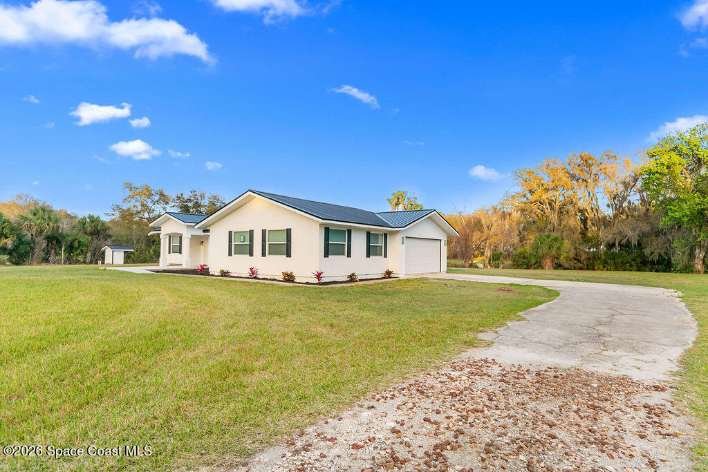1815 Ford Road Mims, FL 32754 - Photo 41 of 59 a front view of a house with garden