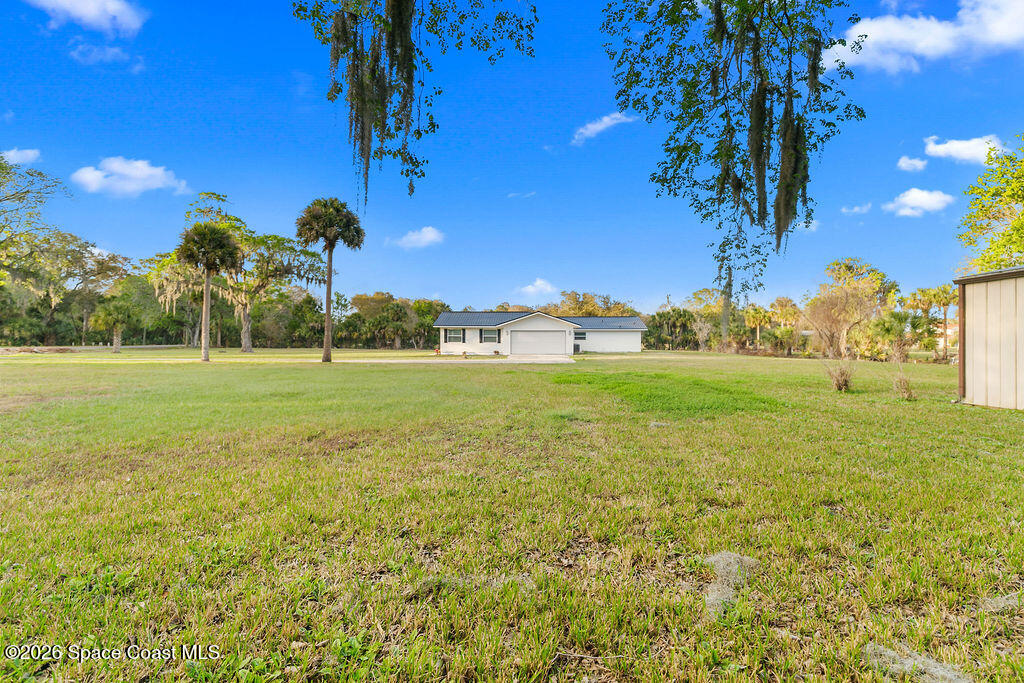 1815 Ford Road Mims, FL 32754 - Photo 45 of 59 a view of a field with grass and palm trees
