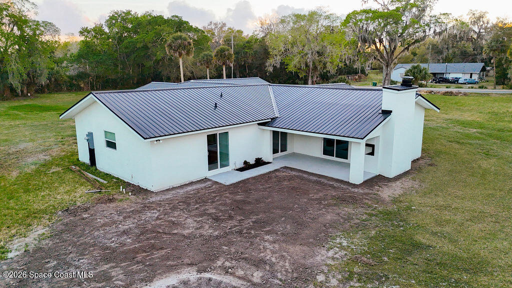 1815 Ford Road Mims, FL 32754 - Photo 48 of 59 a view of a house with a yard and large tree