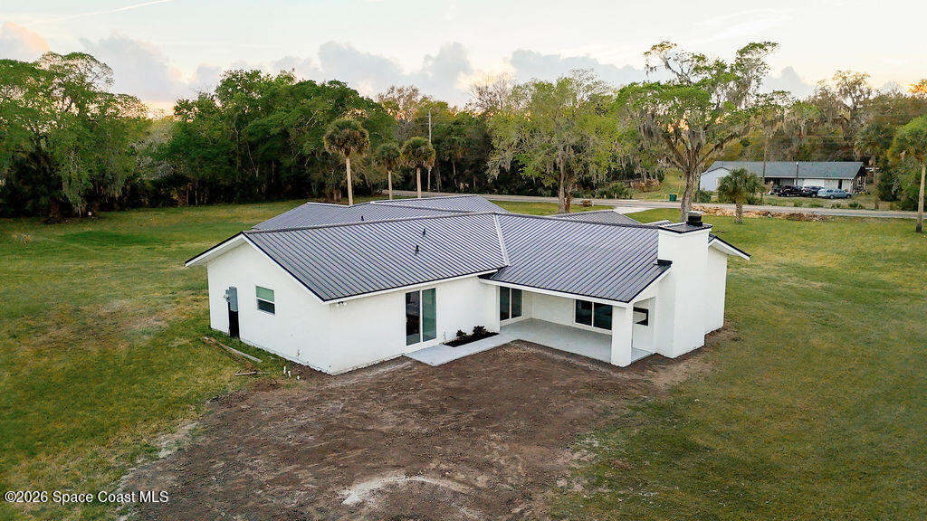 1815 Ford Road Mims, FL 32754 - Photo 49 of 59 a view of a house with a yard and sitting area