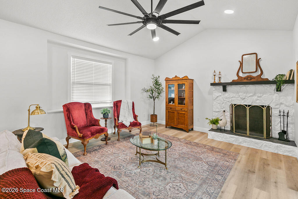 1815 Ford Road Mims, FL 32754 - Photo 5 of 59 a living room with furniture a fireplace and a chandelier