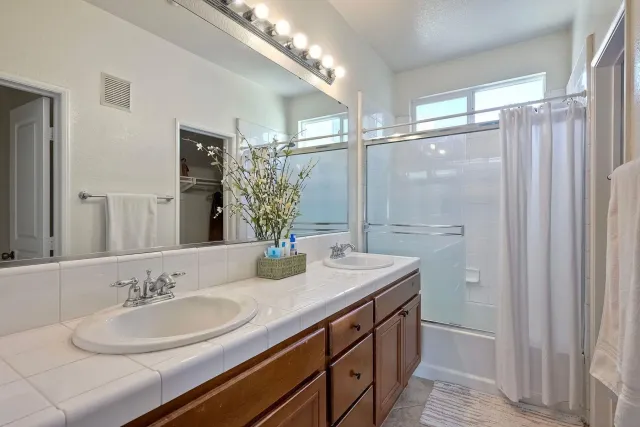 a bathroom with a sink double vanity and a mirror