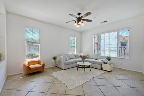 a living room with furniture and floor to ceiling window