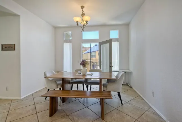 a view of a dining room with furniture and chandelier