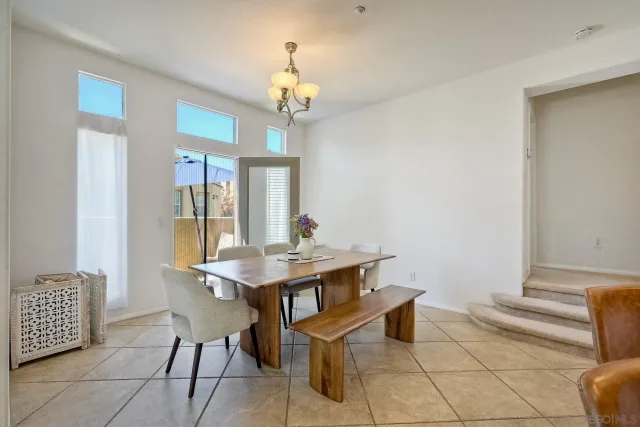 a view of a dining room with furniture and chandelier