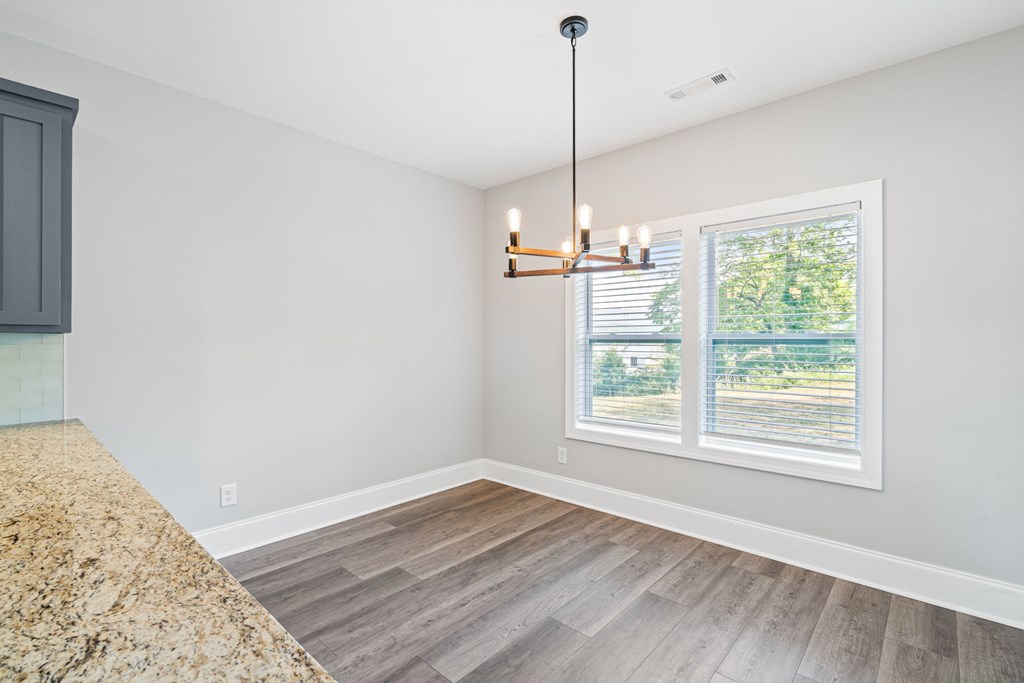 91 Dewey Ridge Lane Hayesville, NC 28904 - Photo 20 of 40 a view of an empty room with wooden floor fridge and a window