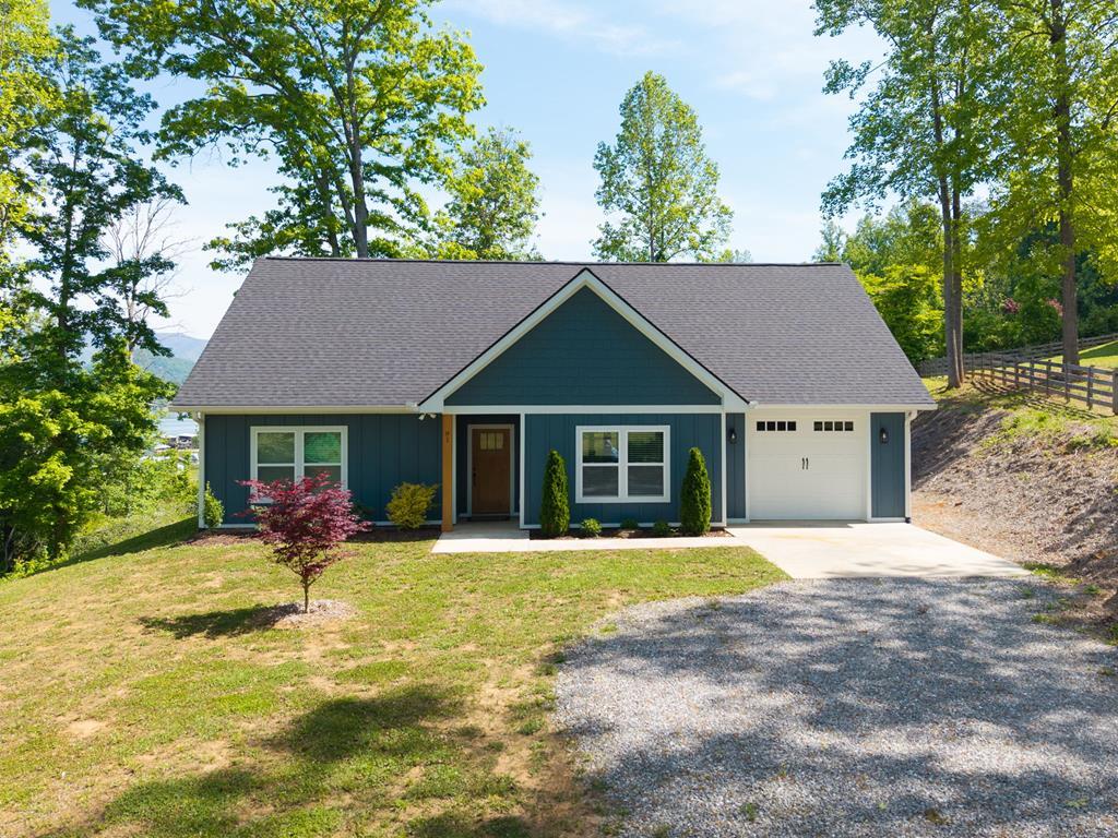 91 Dewey Ridge Lane Hayesville, NC 28904 - Photo 2 of 40 front view of a house with a patio yard and trees