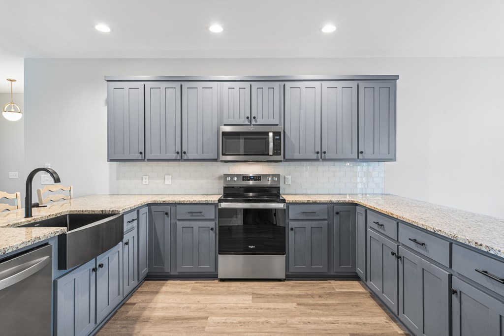 91 Dewey Ridge Lane Hayesville, NC 28904 - Photo 23 of 40 a kitchen with stainless steel appliances granite countertop a sink stove and cabinets