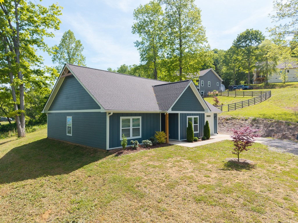 91 Dewey Ridge Lane Hayesville, NC 28904 - Photo 3 of 40 a front view of a house with a yard and trees