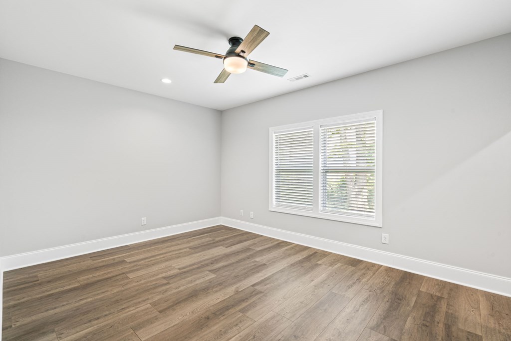 91 Dewey Ridge Lane Hayesville, NC 28904 - Photo 33 of 40 an empty room with wooden floor fan and windows