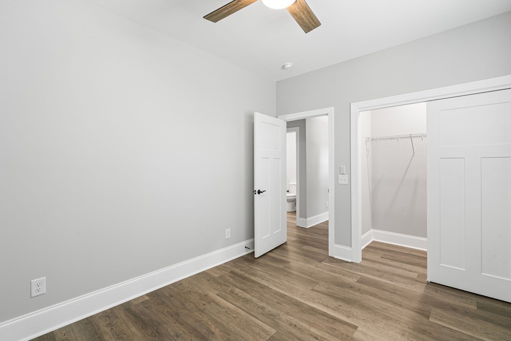 91 Dewey Ridge Lane Hayesville, NC 28904 - Photo 38 of 40 an empty room with wooden floor and ceiling fan