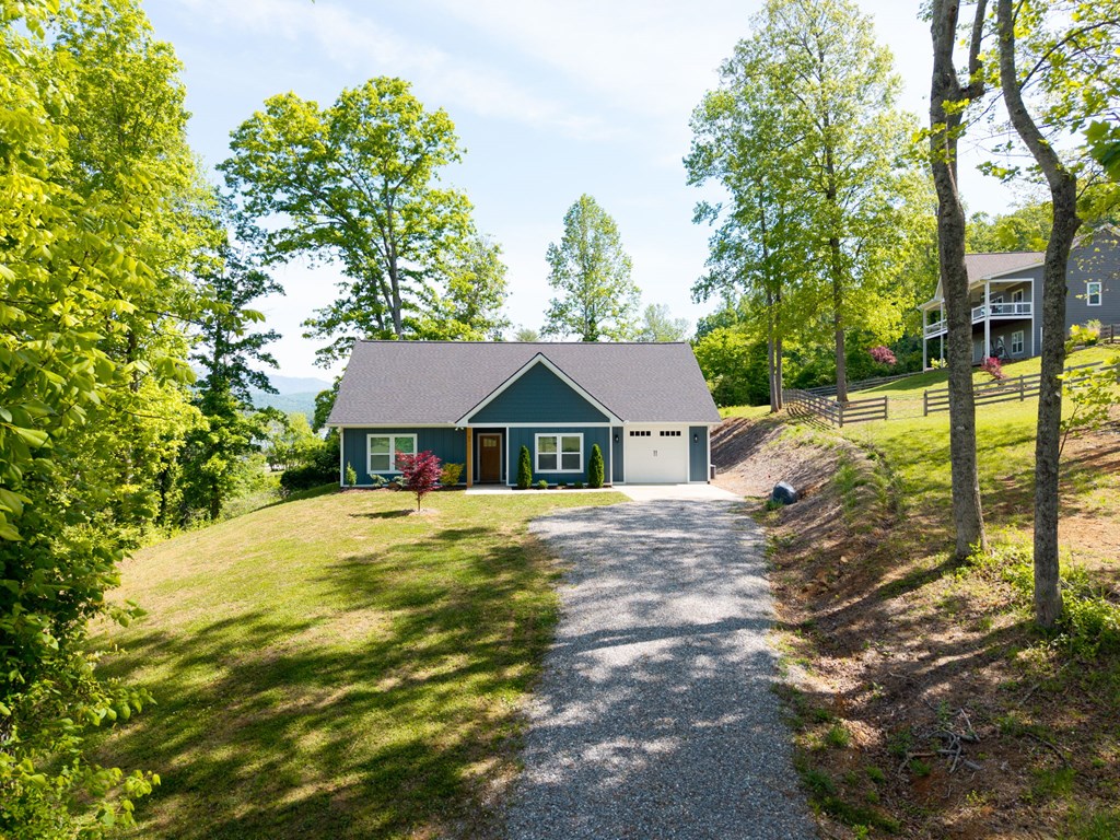 91 Dewey Ridge Lane Hayesville, NC 28904 - Photo 5 of 40 a yellow house with trees in front of it
