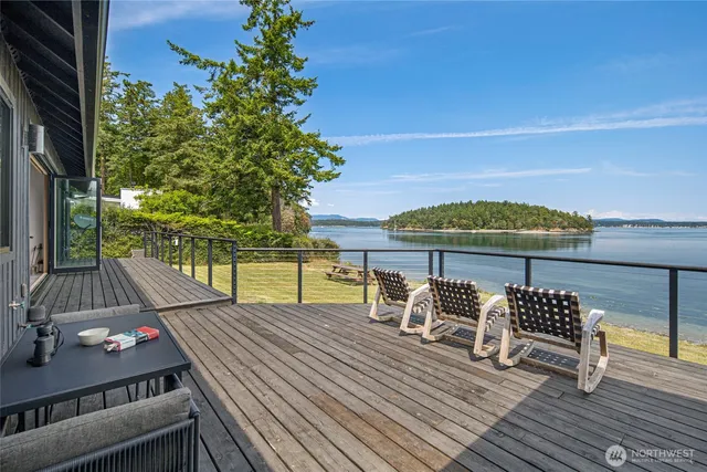 a view of a balcony with chair and wooden floor