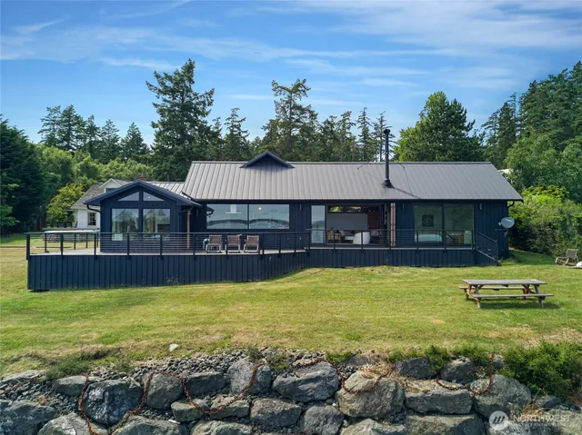 a view of a house with swimming pool and a chairs