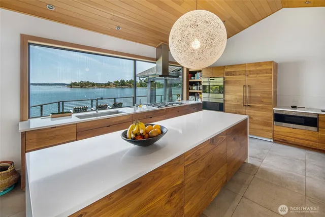 a view of a living room and floor to ceiling window or kitchen
