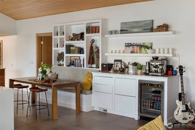 a kitchen with stainless steel appliances granite countertop a table and chairs in it