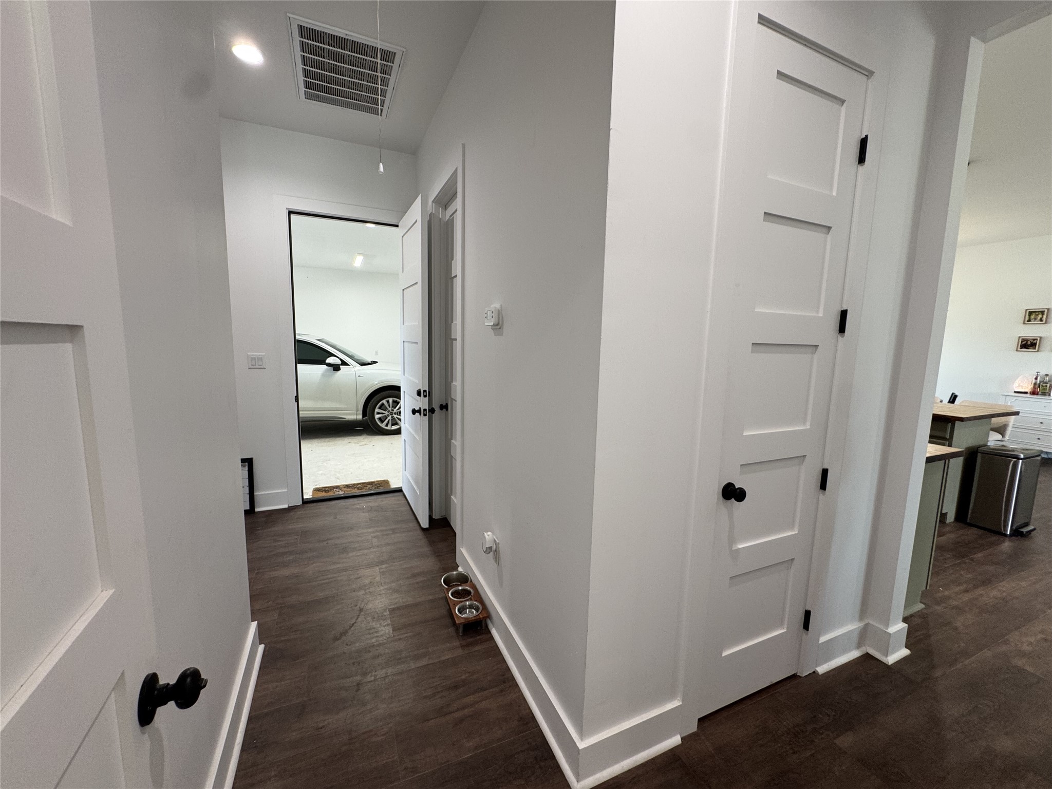 1353 Red Town Road, Unit B Elgin, TX 78621 - Photo 18 of 26 Gleaming hardwood floors and classic paneled doors define this functional, light-filled hallway space.