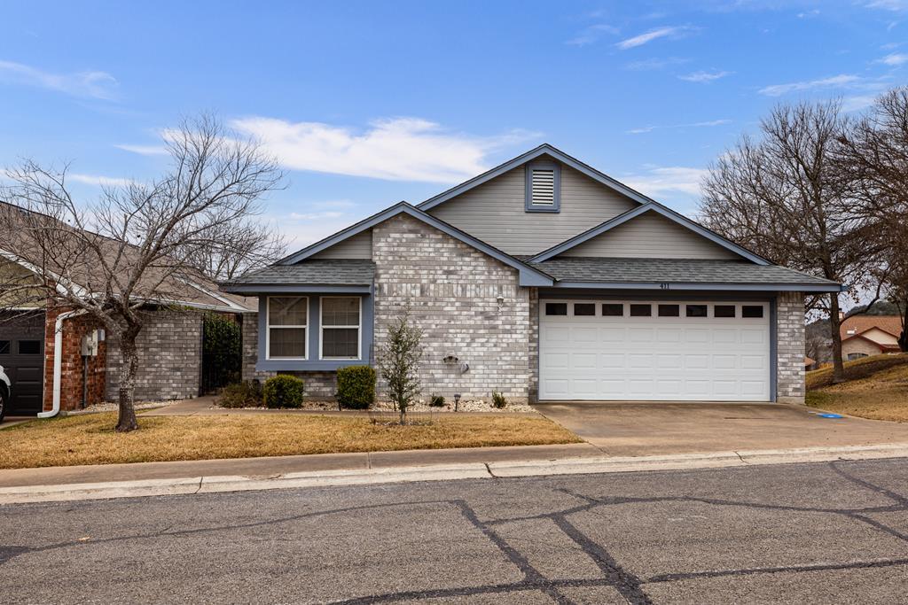 411 Fitch Street Kerrville, TX 78028 - Photo 2 of 33 a front view of a house with a yard and garage