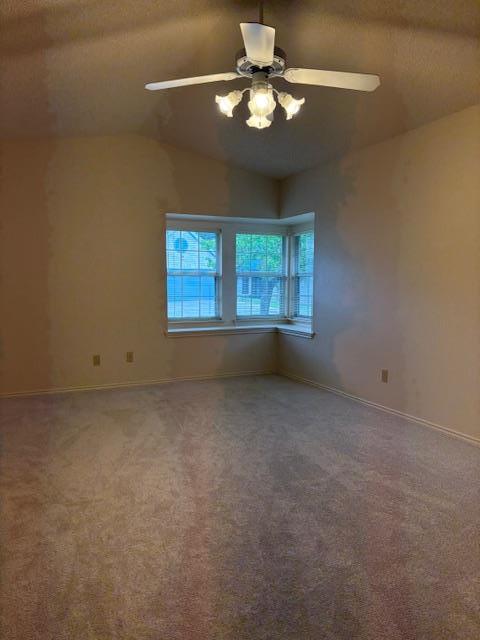411 Fitch Street Kerrville, TX 78028 - Photo 23 of 33 an empty room with a chandelier fan and windows