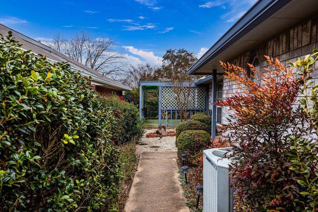 411 Fitch Street Kerrville, TX 78028 - Photo 3 of 33 a pathway of a house with a yard